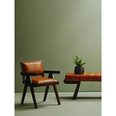 Brown leather armchair with dark wooden frame, contrasting stitching, and angular wooden base seating solution