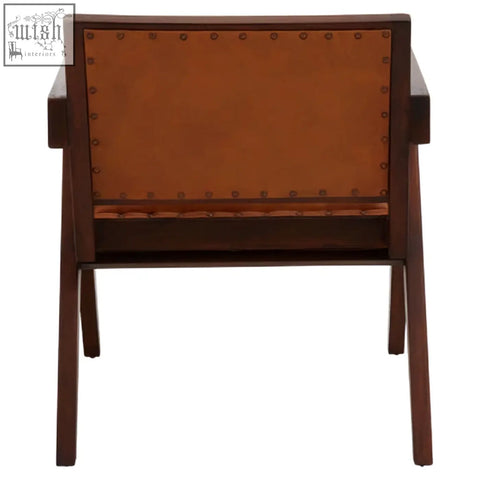 Brown leather-backed armchair with tan leather and teak frame dining chair featuring brass nailhead trim