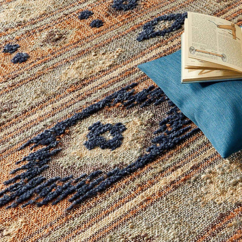 A textured indio multicolour aztec jute rug with earth tones and intricate navy blue and beige geometric patterns
