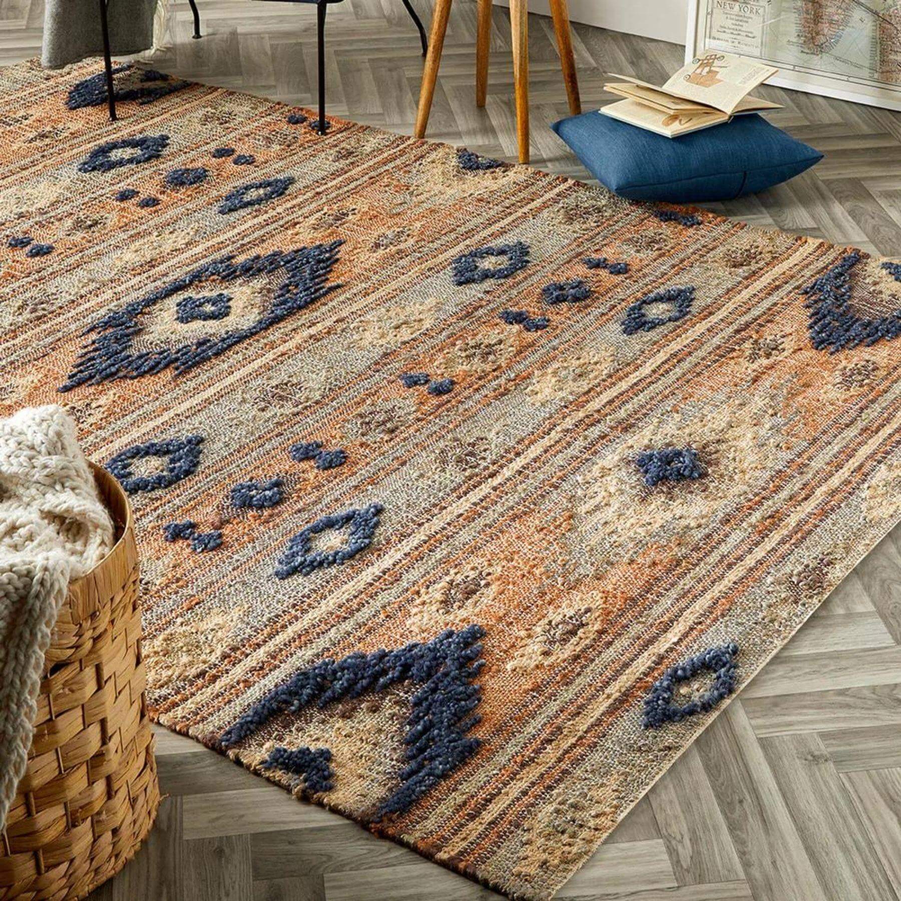 A textured indio multicolour aztec jute rug with orange beige and navy geometric woven pattern