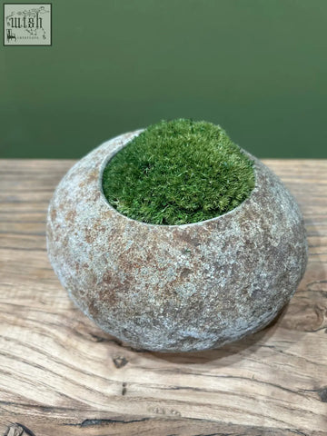 Rounded gray textured indo riverstone planter planted with vibrant preserved moss for natural decor use
