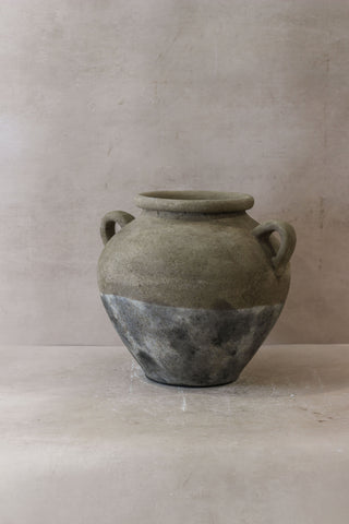 A rustic two-handled ceramic indonesia pot no 27 with matte gray finish and dark metallic band on lower half