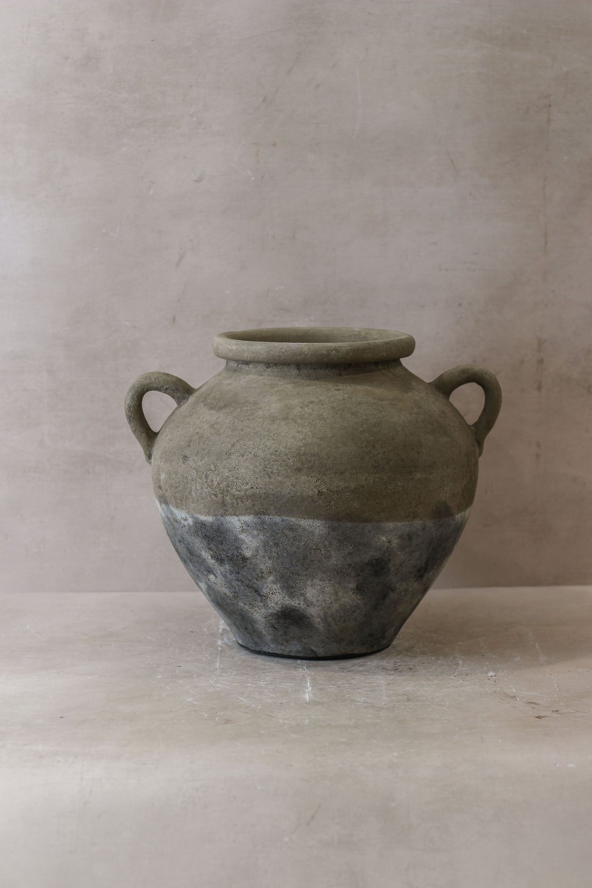 A rustic indonesia pot no 27 ceramic jar with two handles matte gray top and darker textured bottom