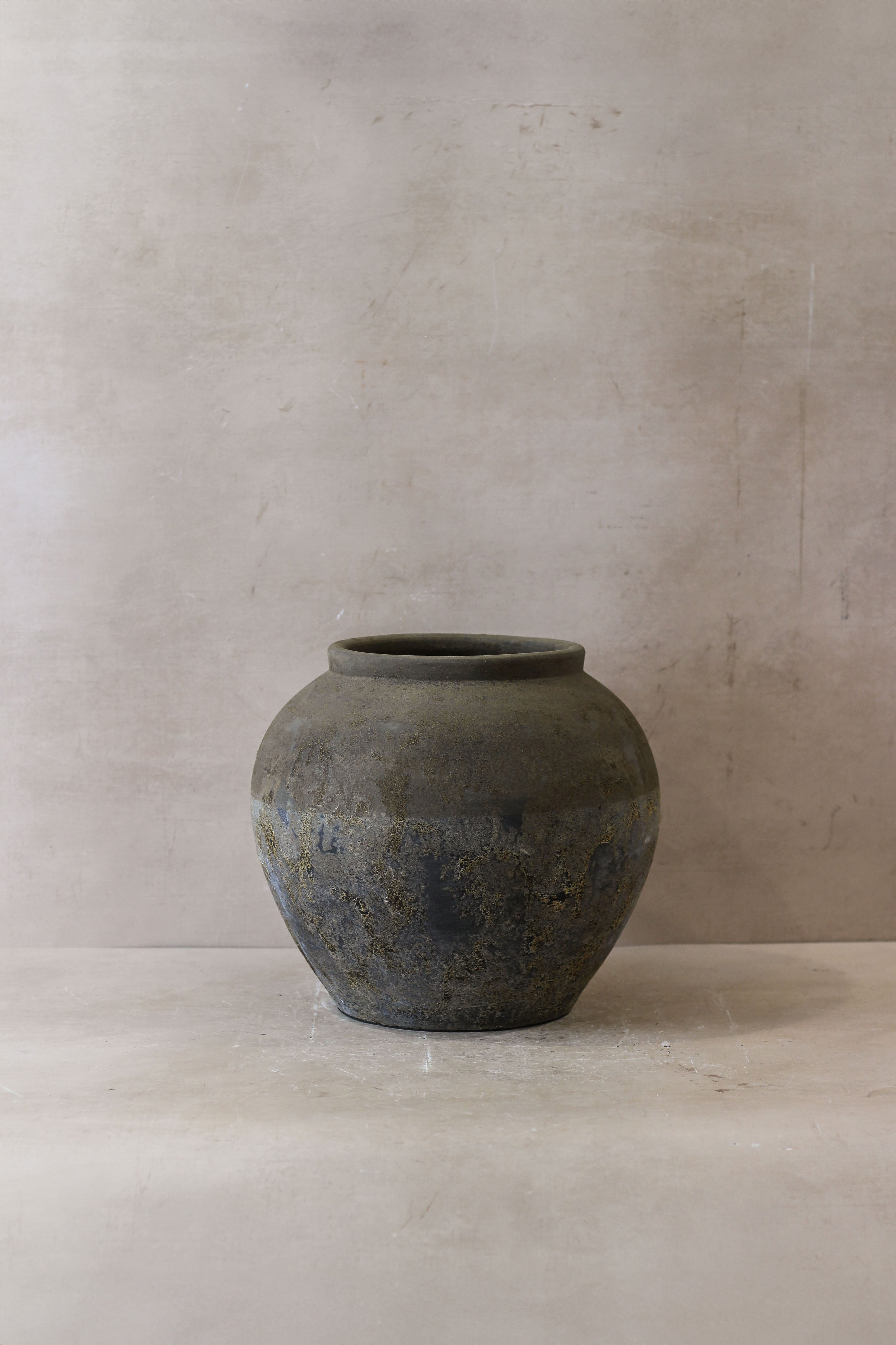 A weathered matte gray ceramic jar with a rounded body and subtle texture from indonesia pot no 28