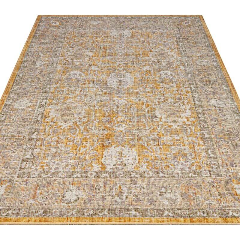 Vintage-style indoor outdoor alexandria rug with faded distressed pattern and muted gold gray floral border design