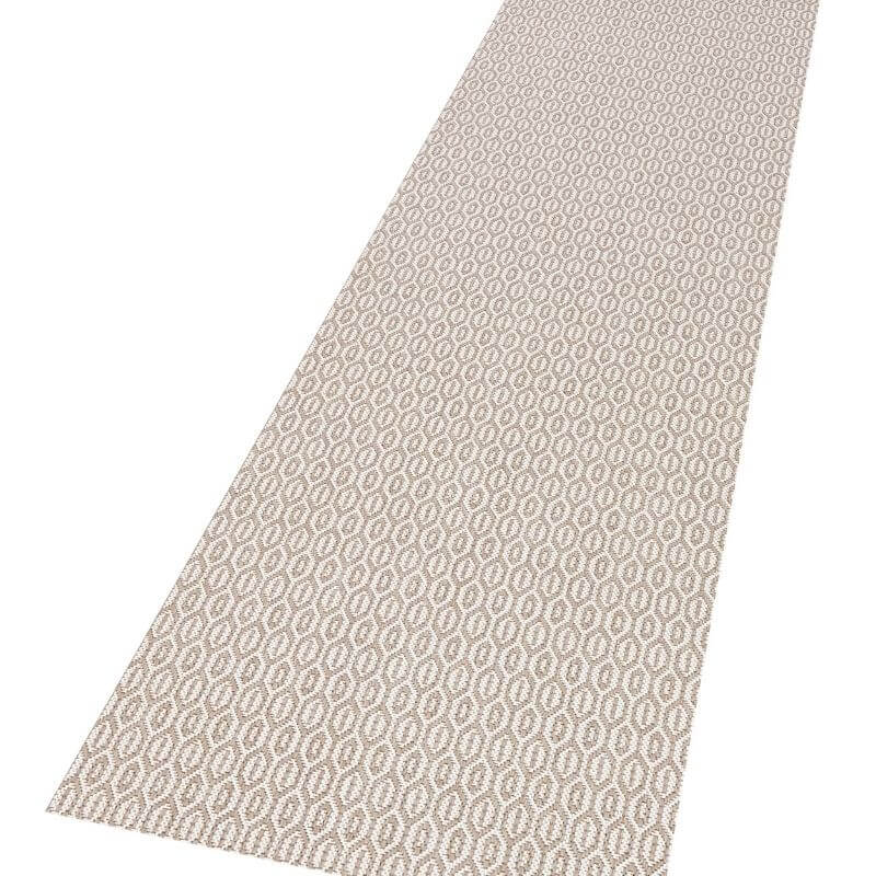 Beige indoor outdoor coin rug with a repeating lighter geometric pattern perfect for indoor outdoor use