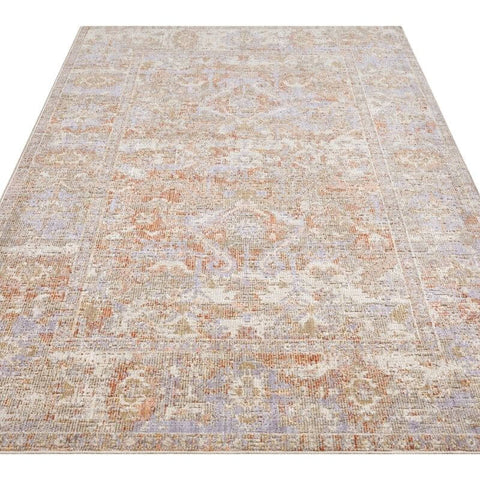 Vintage-style indoor outdoor port said rug with a distressed medallion pattern in beige dusty rose and soft gray tones