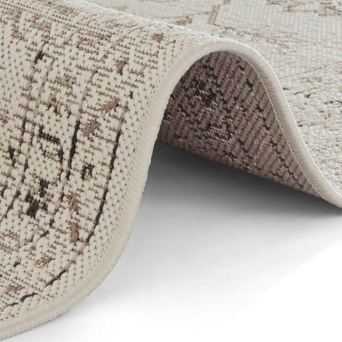 Beige and taupe woven indoor outdoor rug navarino with textured patterned surface and bordered design