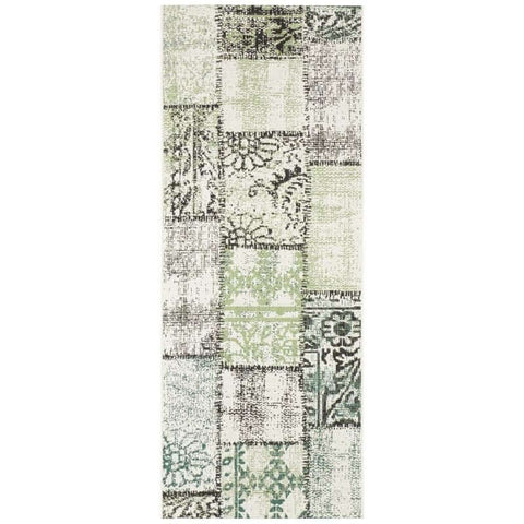 Vintage-style indoor outdoor symi patchwork runner rug with distressed off-white base and faded green black floral patterns