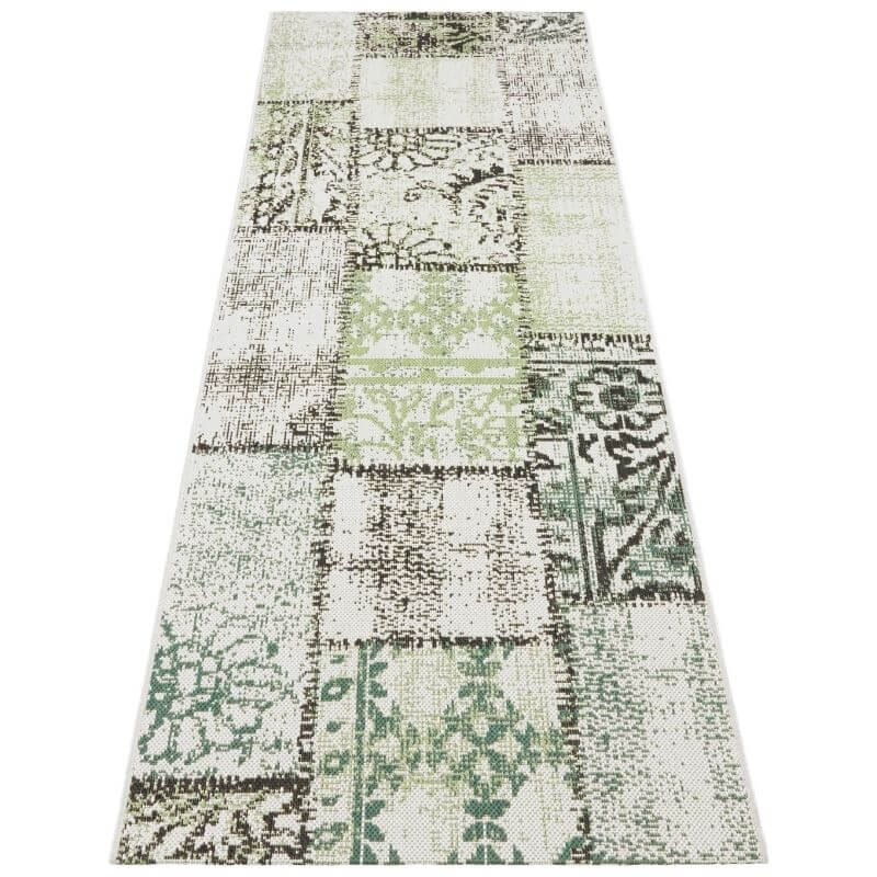 Indoor outdoor symi rug patchwork runner with vintage floral and geometric patterns in muted green beige and gray tones on woven textile base