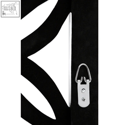 Black metal wall hanging with silver d-ring hook shown on back of indus antique white lattice frame wall mirror