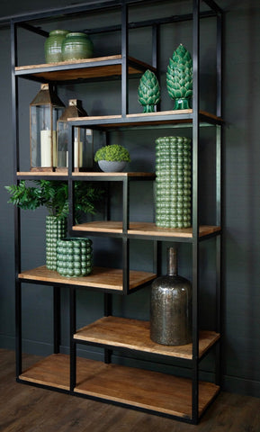 Industrial multi shelf unit with black metal frame and natural wood shelves displaying green ceramic art pieces