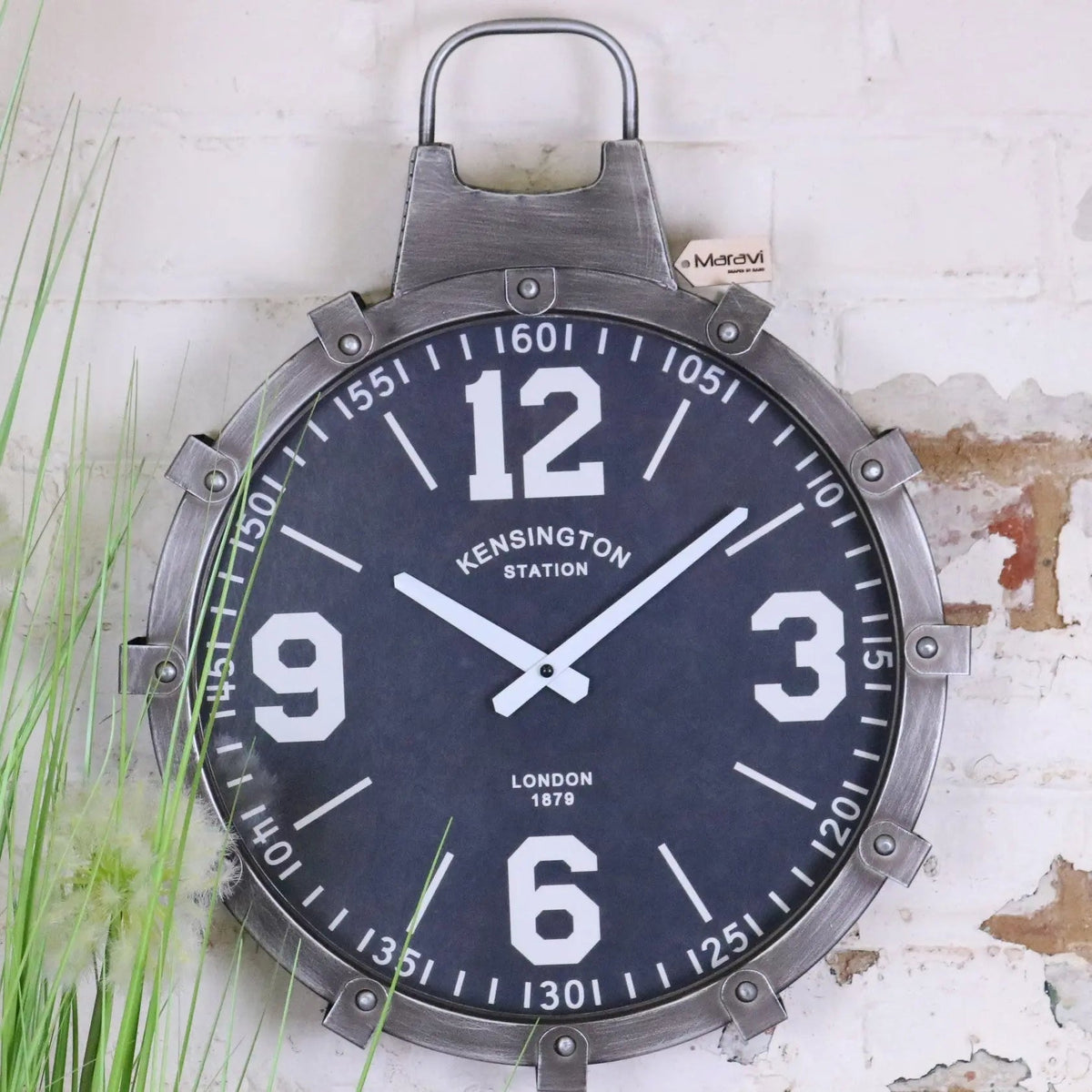 Industrial style wall clock with dark navy face white numerals weathered gunmetal grey riveted frame and hanging loop