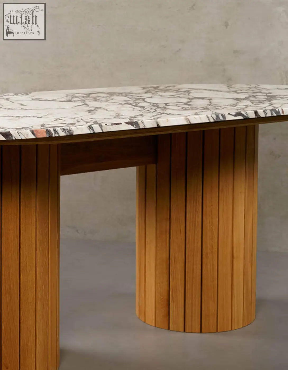 Ionescu oval dining table with white marble dining top veined in black and pink and light oak cylindrical legs