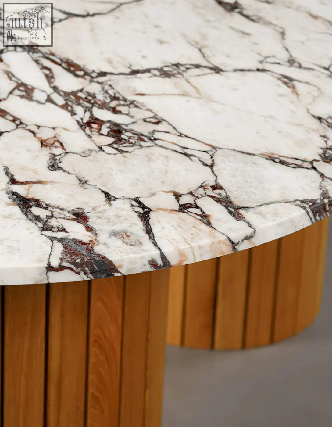 Ionescu oval dining table with white marble top and black reddish brown veining on wooden slat base perfect for dining room