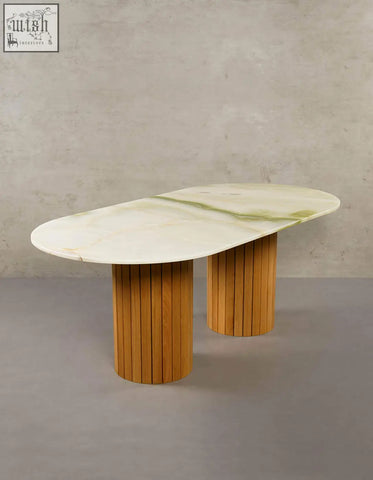 Ionescu oval dining table with a white and green veined marble top and wooden legs perfect for a dining room setup