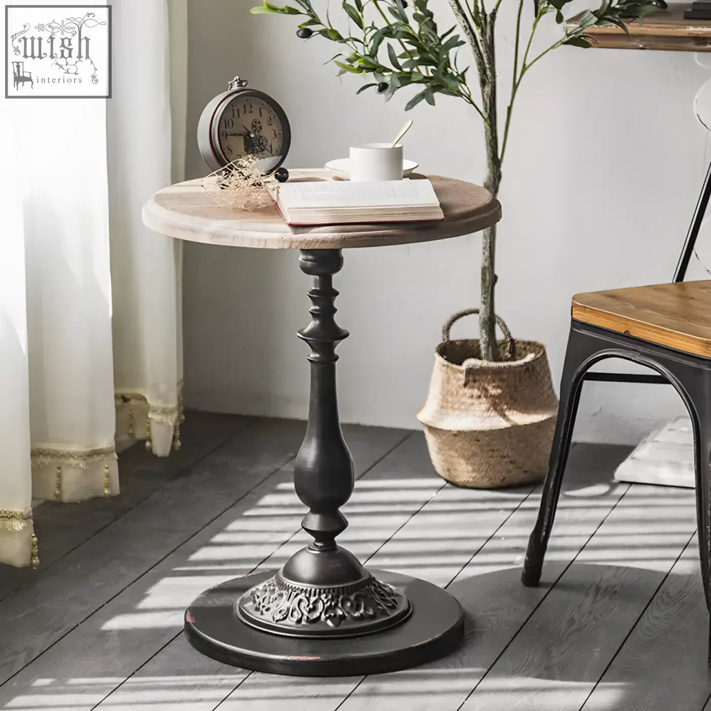 Iphigenia retro side table with a rustic wooden top and ornate black wrought iron pedestal base perfect for any room