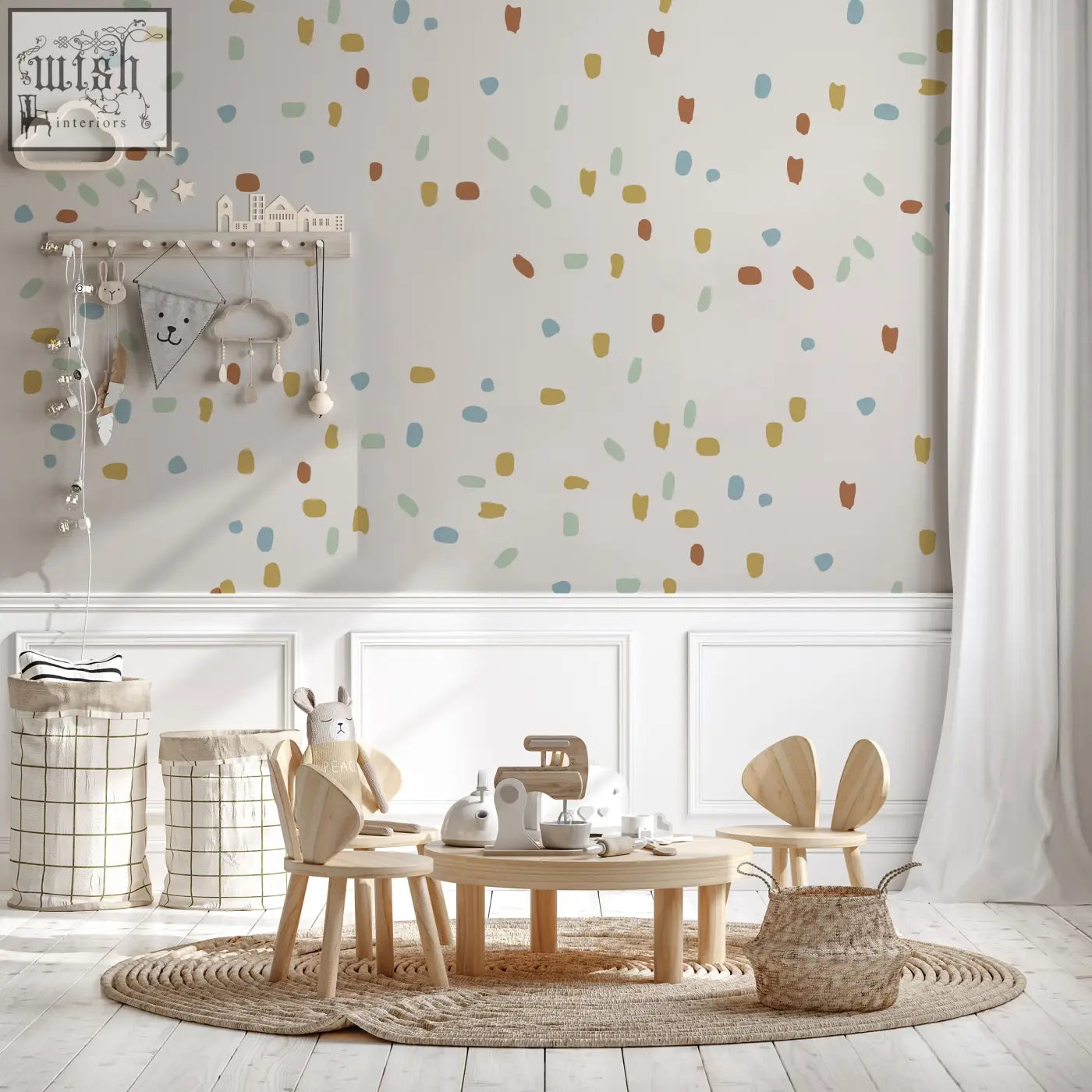 Light wood children’s table with rounded edges and bunny ear chairs featured with five color irregular shape dot wall decals