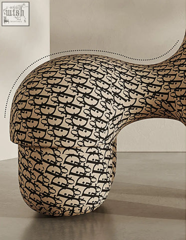 Cream-colored isabeau kids animal armchair with black monogram pattern, perfect for a coffee table set area