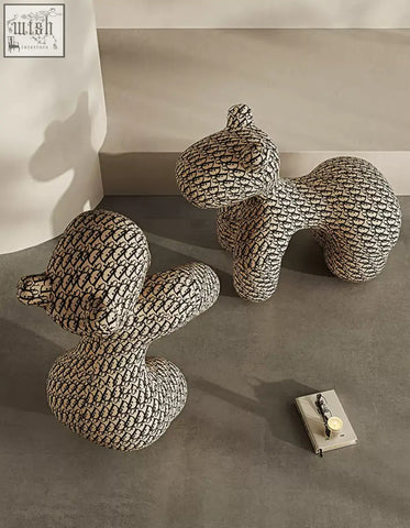 Two plush black and white monogram dog-shaped isabeau kids animal armchairs perfect for a stylish coffee table set