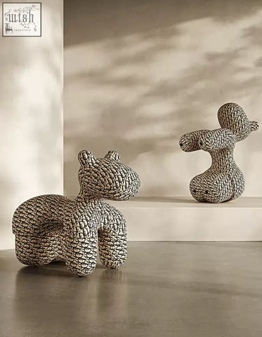 Two whimsical textured ceramic animal sculptures in monochrome pattern for isabeau kids animal armchair coffee table set