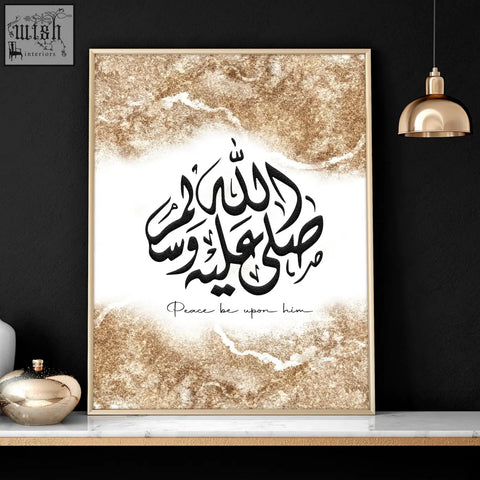 A set of 2 bedroom wall art prints featuring islamic calligraphy with black script and gold marble accents in gold frames