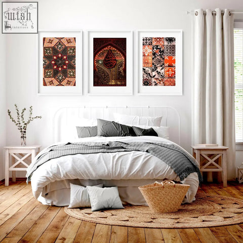 White framed islamic geometry wall art prints with intricate red orange black and beige patterns above bed