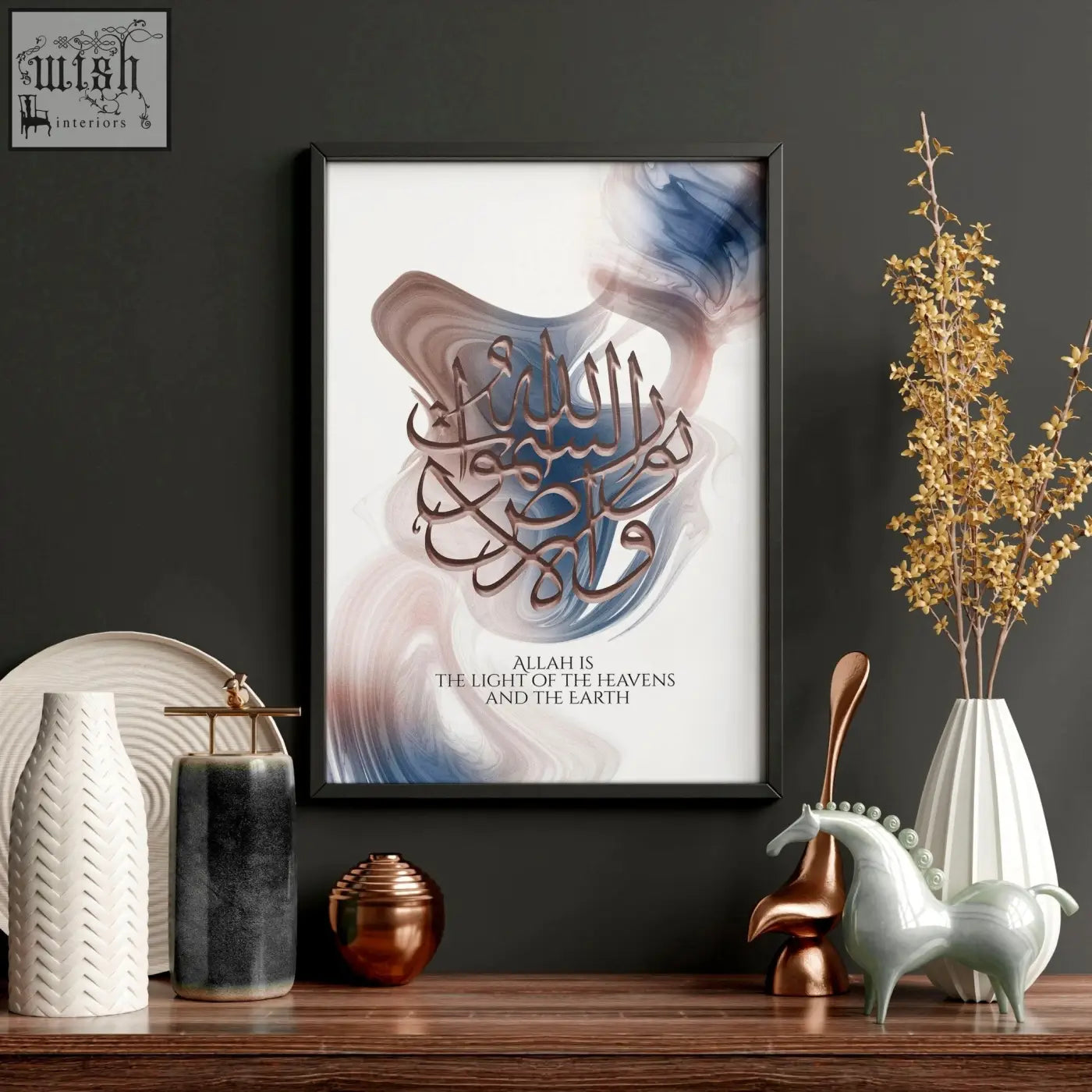 Black-framed wall art print featuring elegant brown and gold arabic calligraphy on a blue and beige abstract background
