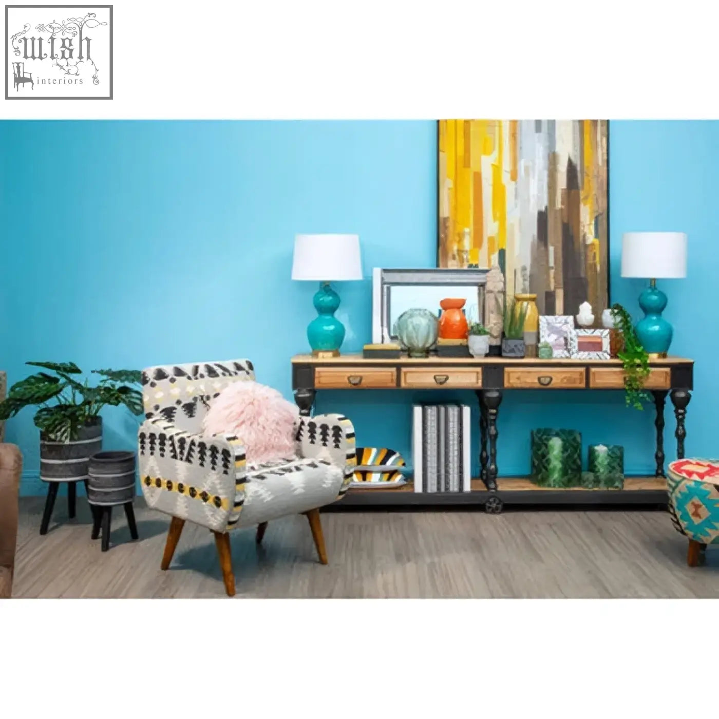 Patterned armchair with white base black and gold geometric design and wooden legs complements a white wall mirror focal point
