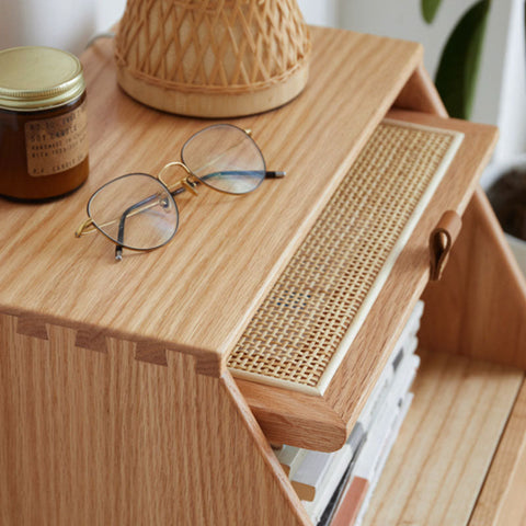 Light wood izabella bedside table organizer with woven cane front panel and leather pull handle in oak finish