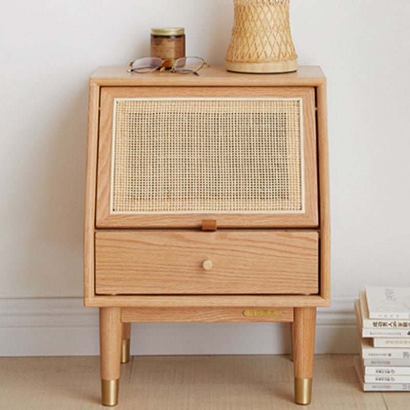 Oak izabella bedside table with light wood, woven cane front panel, and brass-finished legs for bedroom use