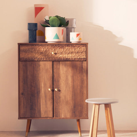 Warm-toned wooden cabinet with hammered metal drawer front and matching knobs for jada small abstract planter setup