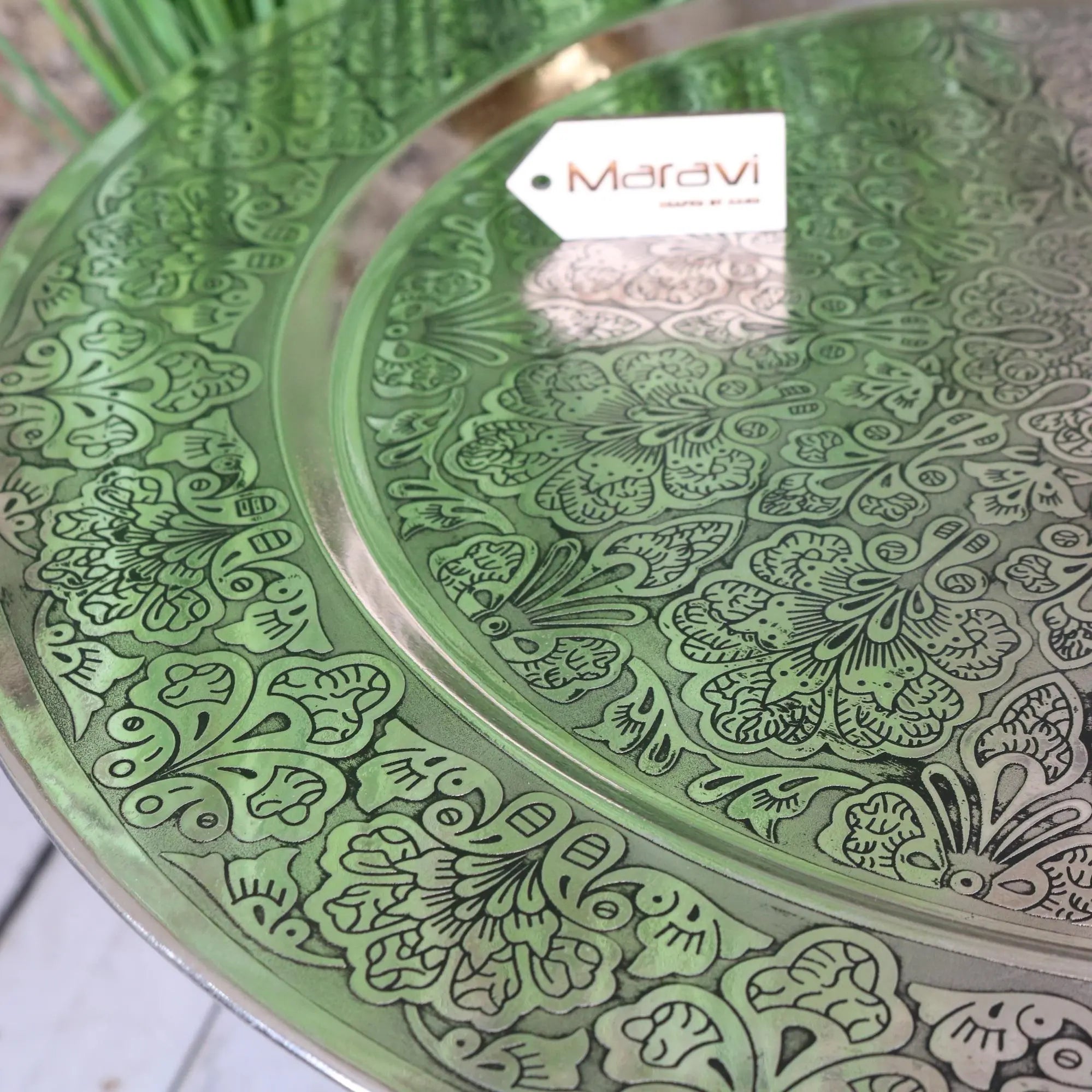 Green ornate metal moroccan tray table with intricate floral engravings and silver rim jadida 60cm tray table