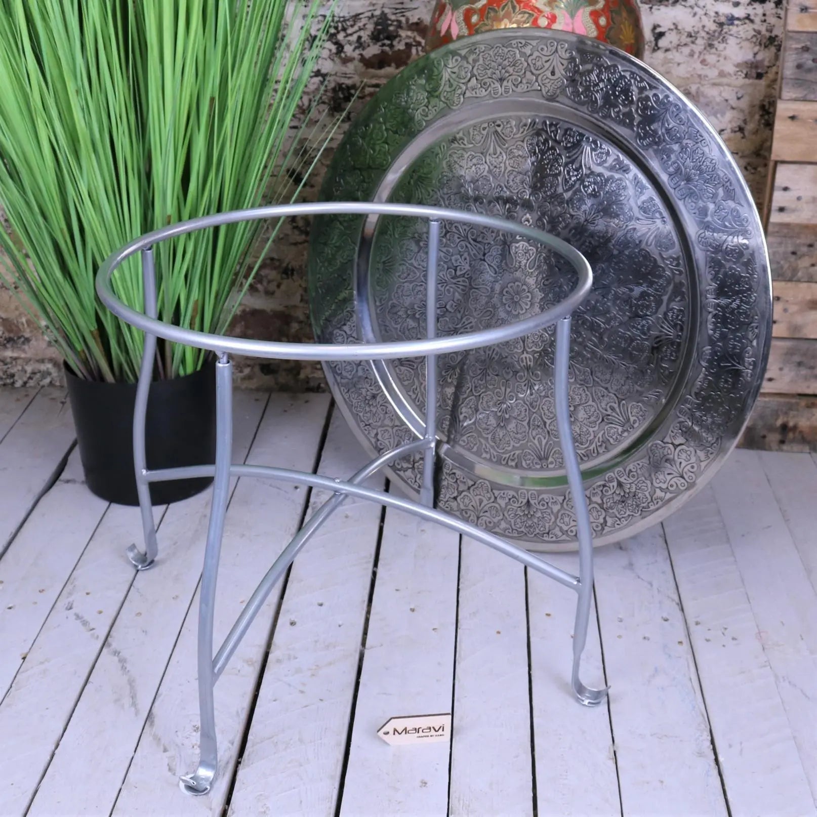 Silver metal moroccan tray table with curved legs and circular top frame perfect for stylish serving