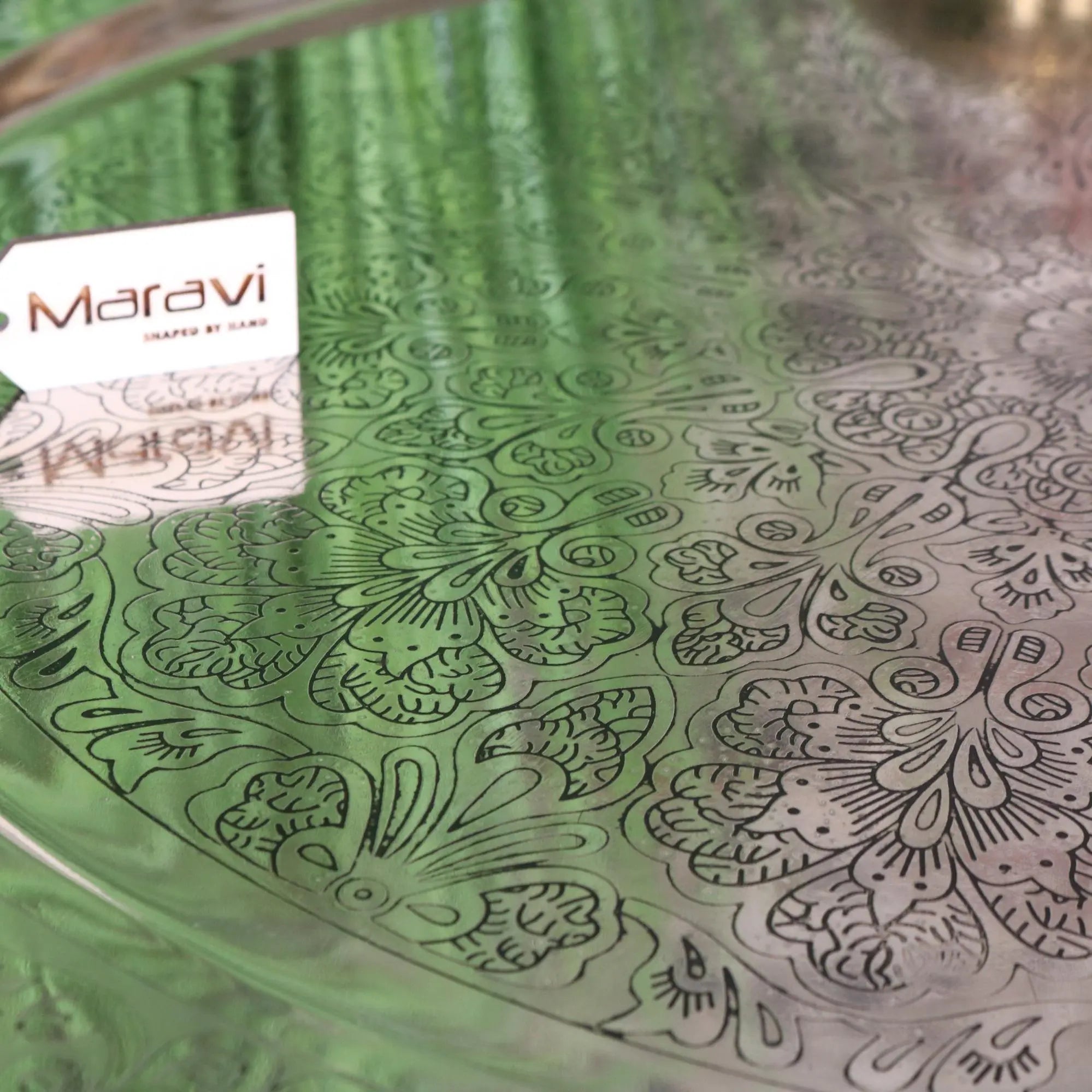 Green glass moroccan tray table with intricate black floral engravings and maravi brand tag 80cm jadida tray table