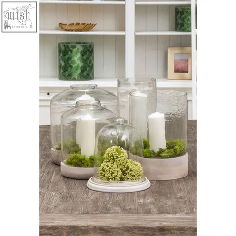 Jain large hurricane candle holder with clear glass cloches on beige ceramic bases housing moss and white candles