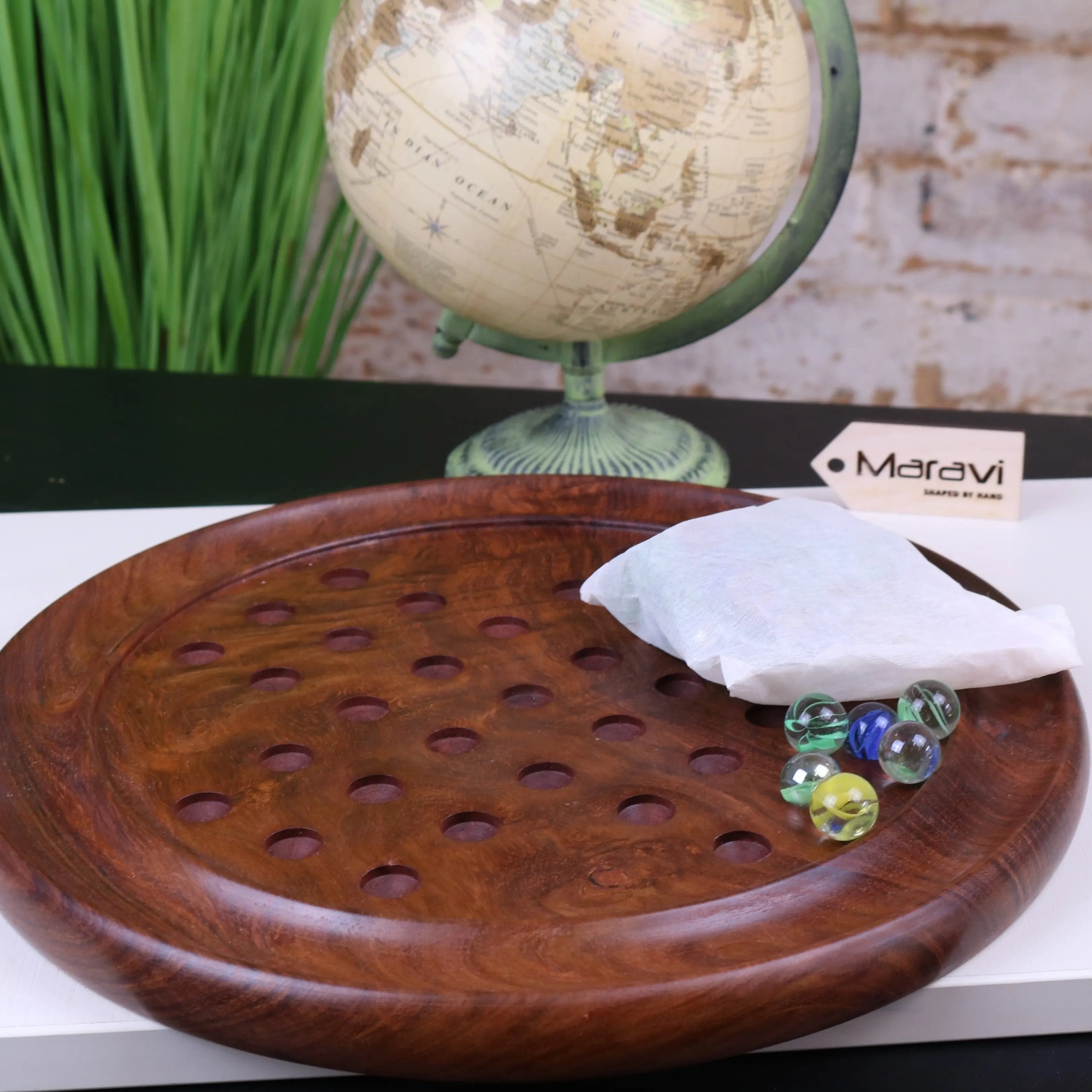 Rich brown wooden solitaire game board with circular design and evenly spaced holes from jajur wooden solitaire game