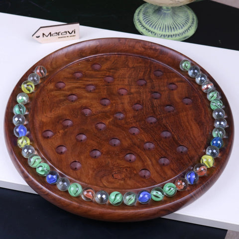 Jajur wooden solitaire game with rich brown wood and colorful glass marbles in a circular arrangement on the board