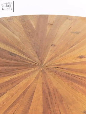 Jana round fir wood dining table with a circular sunburst pattern top made of light to medium-toned fir wood planks