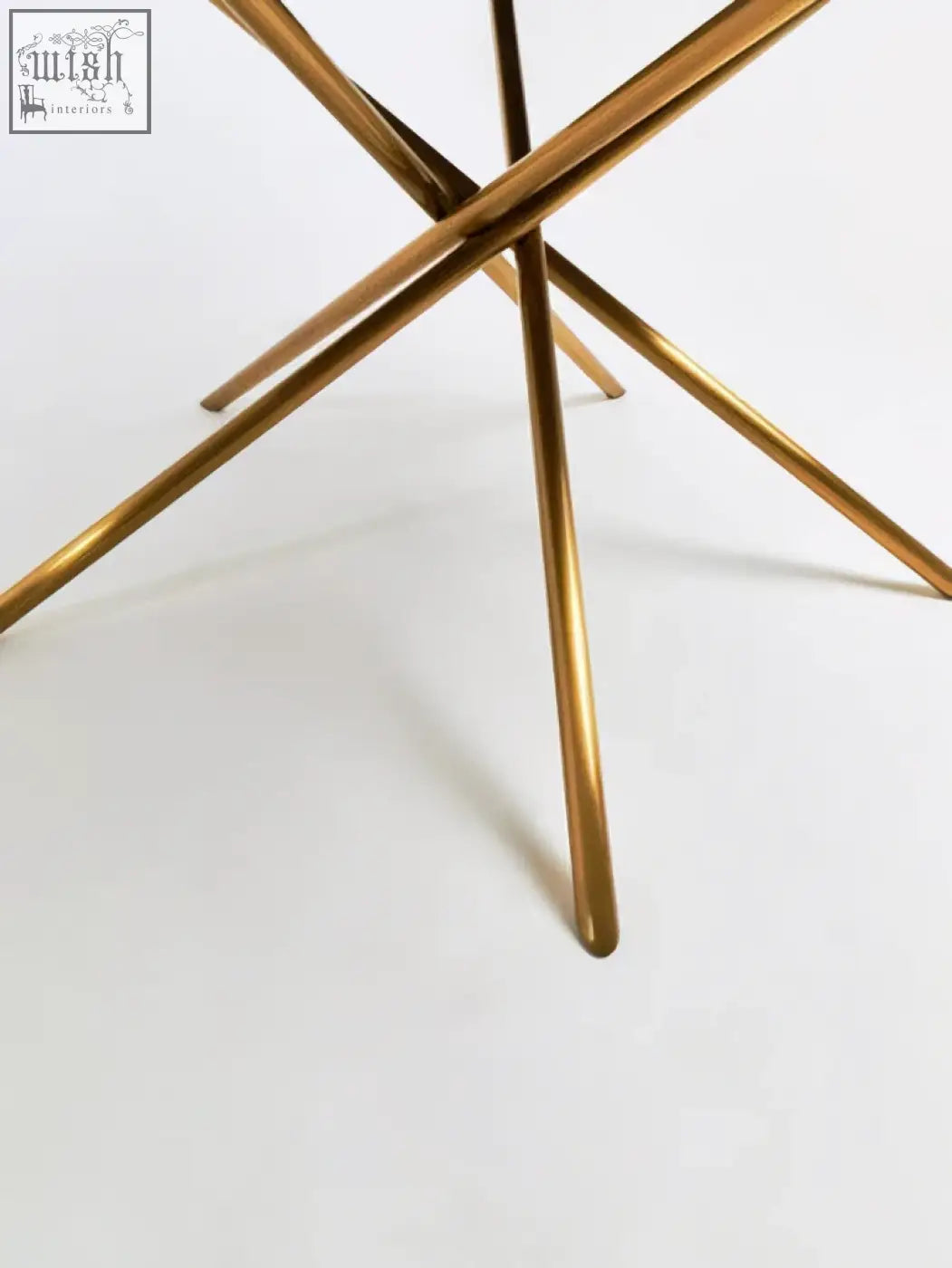 Gold-finished metal table legs with a sleek starburst design for the jana round fir wood dining table with splayed legs