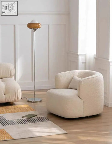 Cream-colored plush janet armchair with soft textured fabric finish, velvet armchair alternative to green velvet armchair