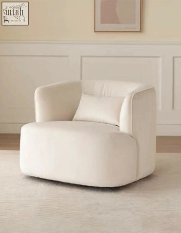 Cream-colored velvet armchair with plush rounded design and matching cushion from the janet armchair collection