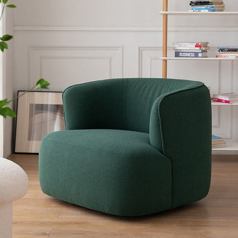 Deep emerald green jaotoo armchair with plush velvet boucle upholstery and rounded modern cozy design