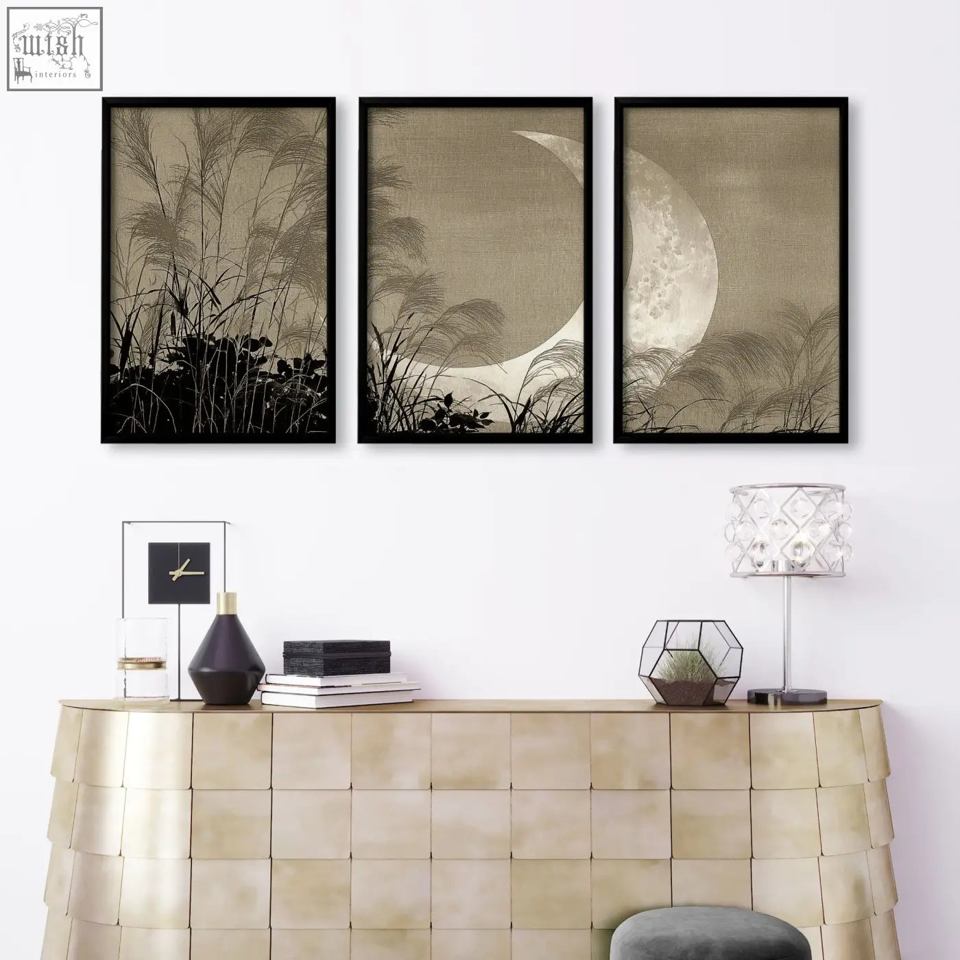 Three black-framed sepia living room canvas art with crescent moon and reeds above gold-toned console table
