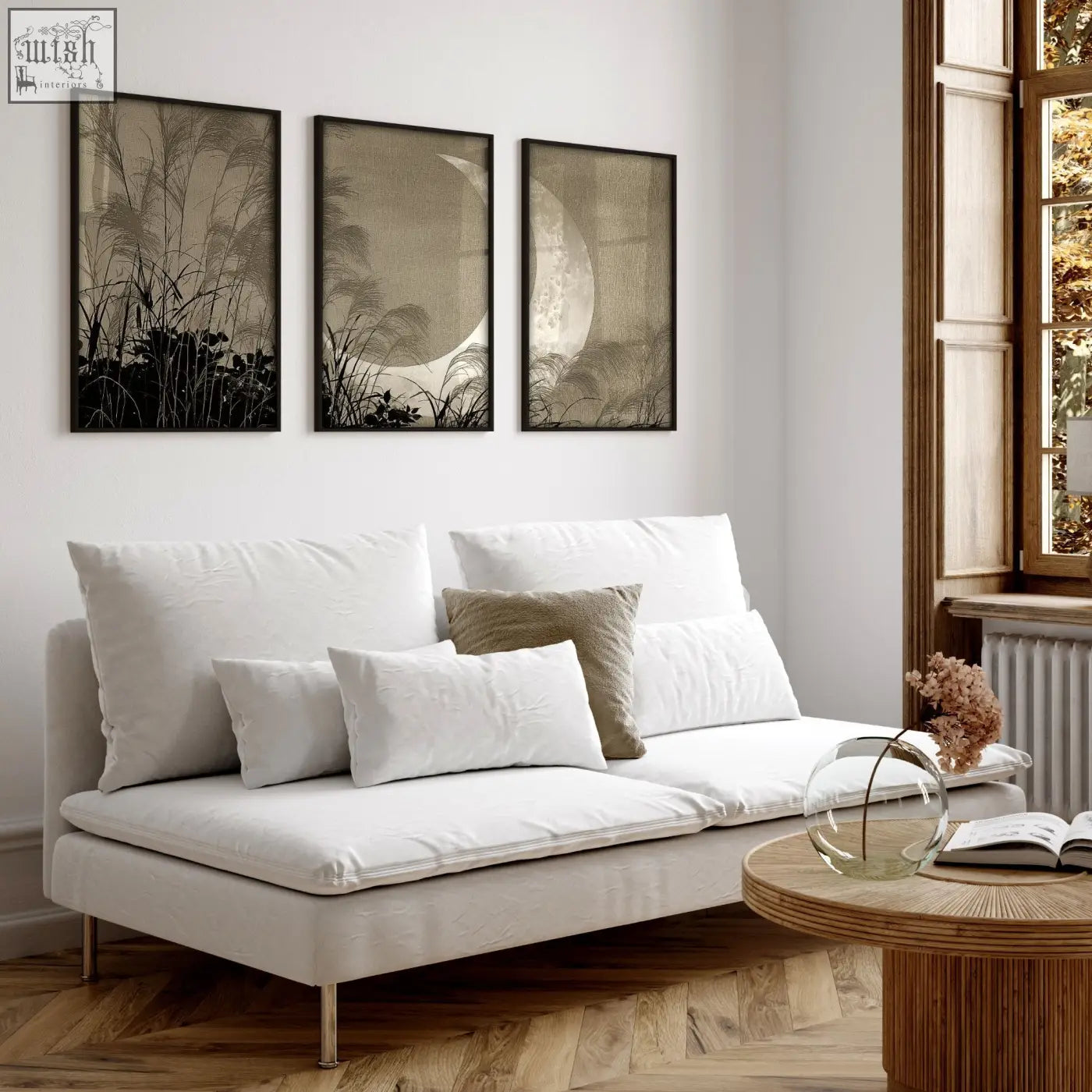 White upholstered sofa with metal legs and cushions paired with japandi crescent moon pampas grass living room canvas art set of 3