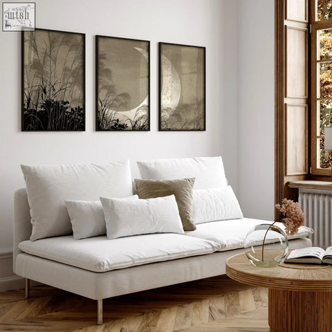 White upholstered sofa with metal legs and cushions paired with japandi crescent moon pampas grass living room canvas art set of 3