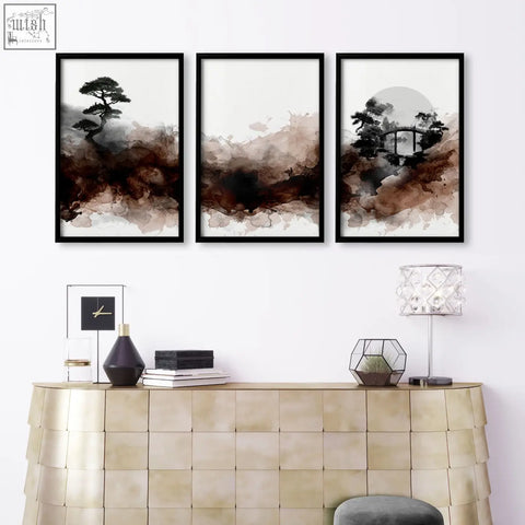 Three framed japandi ink wash wall art canvases with brown tones hang above a gold console in the living room