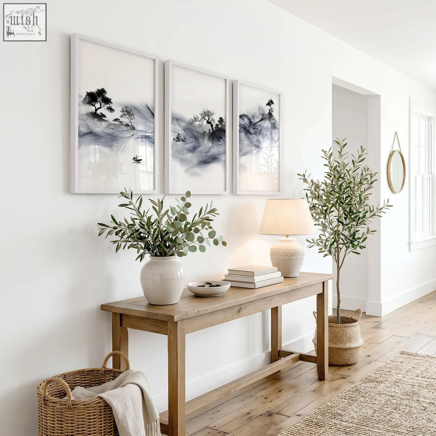 A white ceramic vase with green eucalyptus branches complements a set of 3 ink wash landscape art prints uk