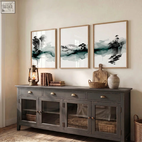Dark gray wooden sideboard with glass-paneled doors and brass handles shown below japanese wall hangings ink wash landscape set