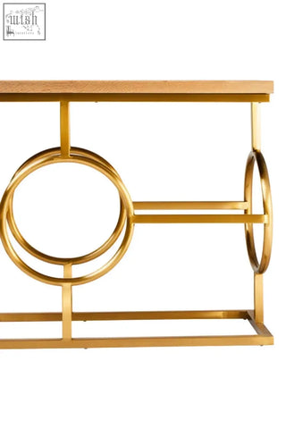 Gold-finished metal jarloi console table with light wood top and circular geometric design for stylish living spaces